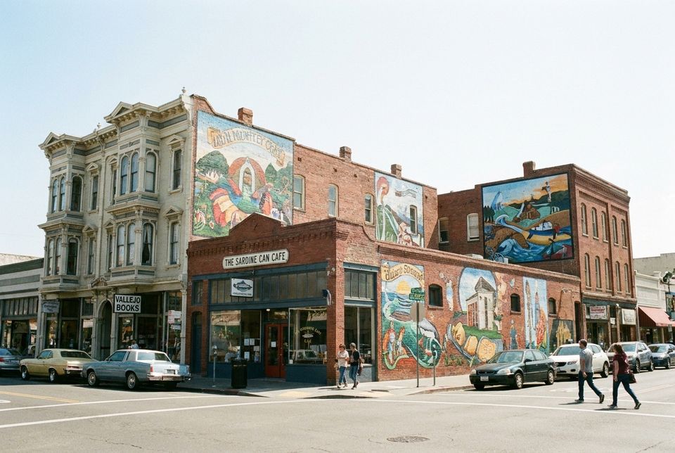 Downtown Vallejo California street with Victorian buildings local shops and mural art on walls