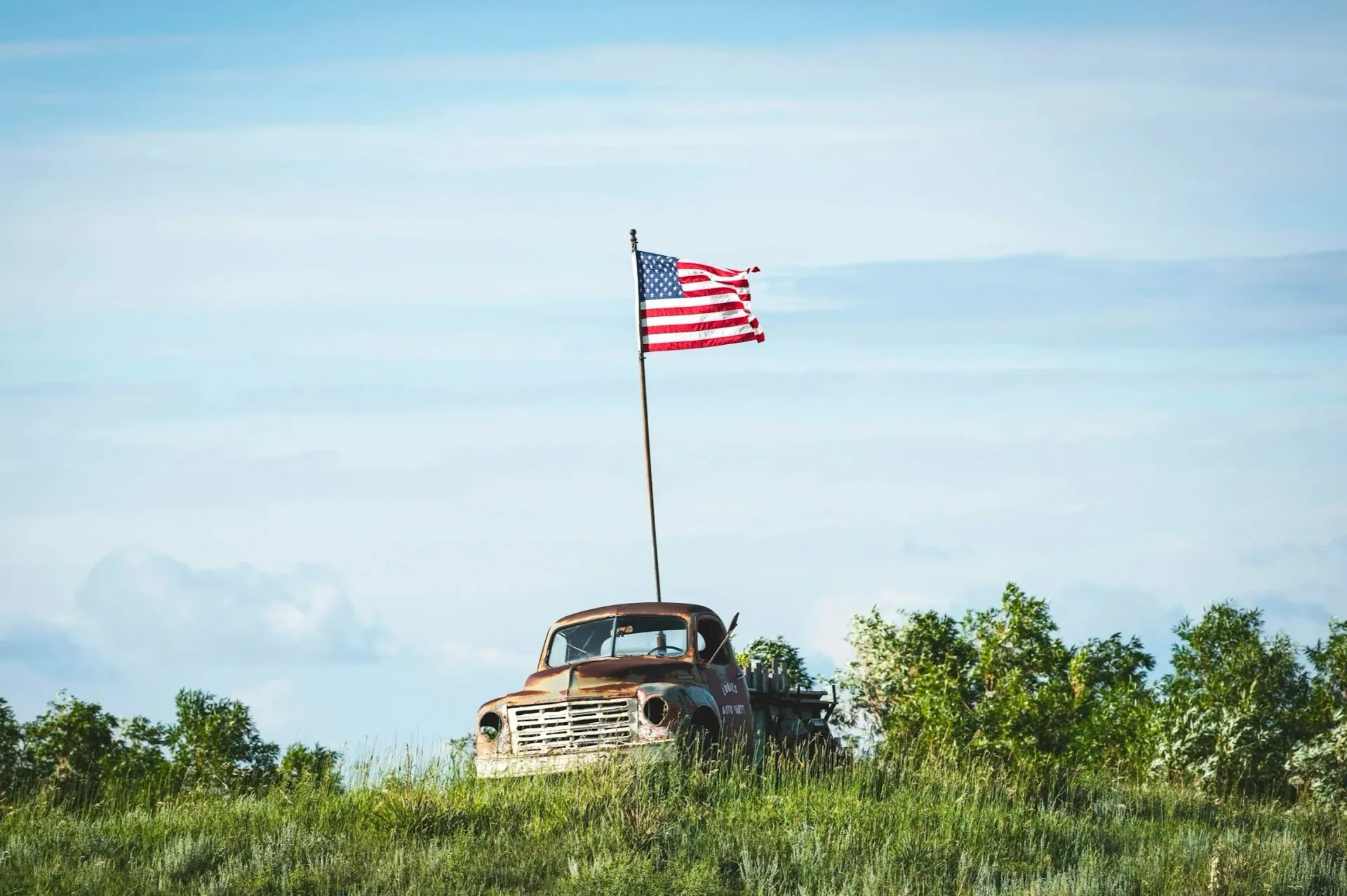 A vintage truck flying the American flag on a Georgia field