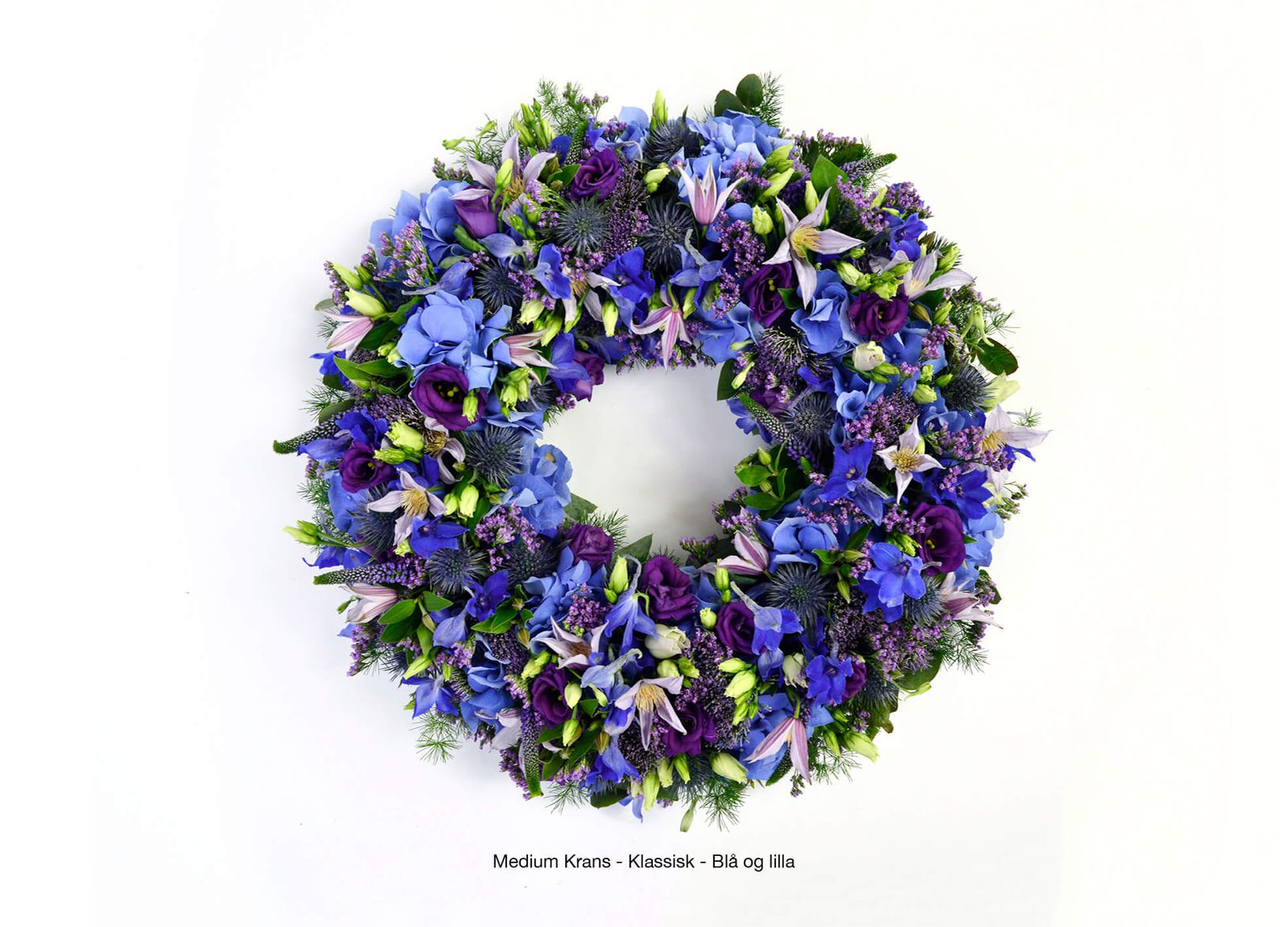 Blue and purple funeral wreath with iris, ranunculus and thistle. Art direction and image editing of dignified floral arrangement for memorial service