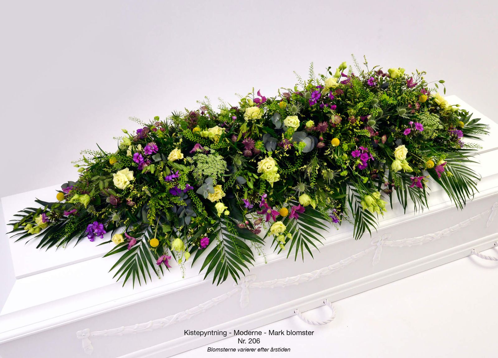 Coffin floral arrangement photography showcasing purple and yellow blooms in dignified presentation