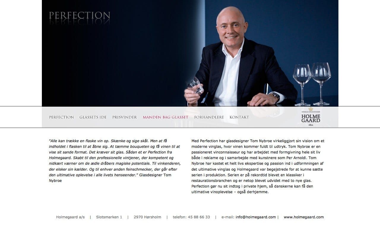 Creative direction for Perfection glassware website portrait of designer Tom Nybroe holding a wine glass against blue backdrop