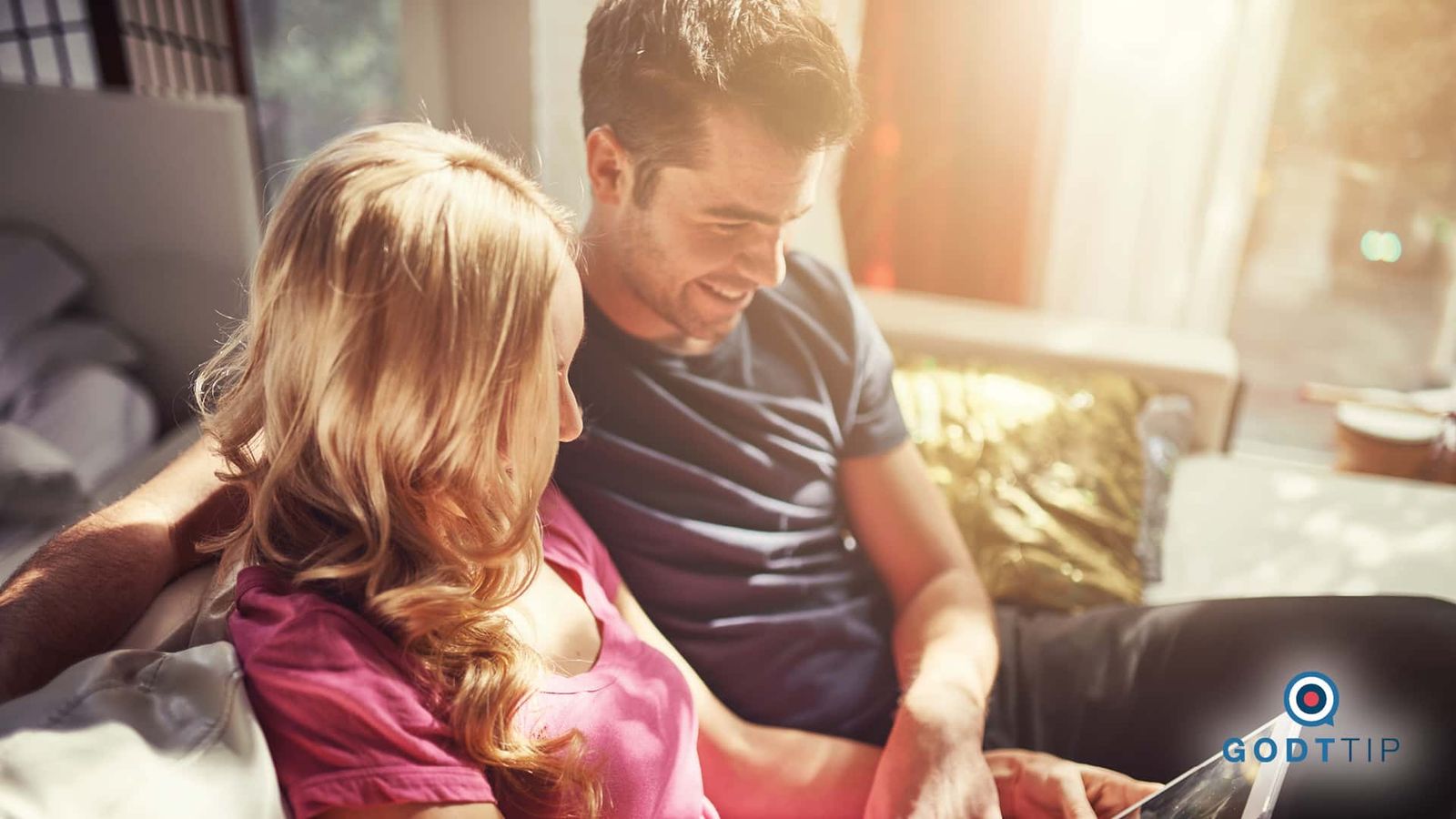 Interaction design featuring two people collaborating on a tablet interface in warm natural light