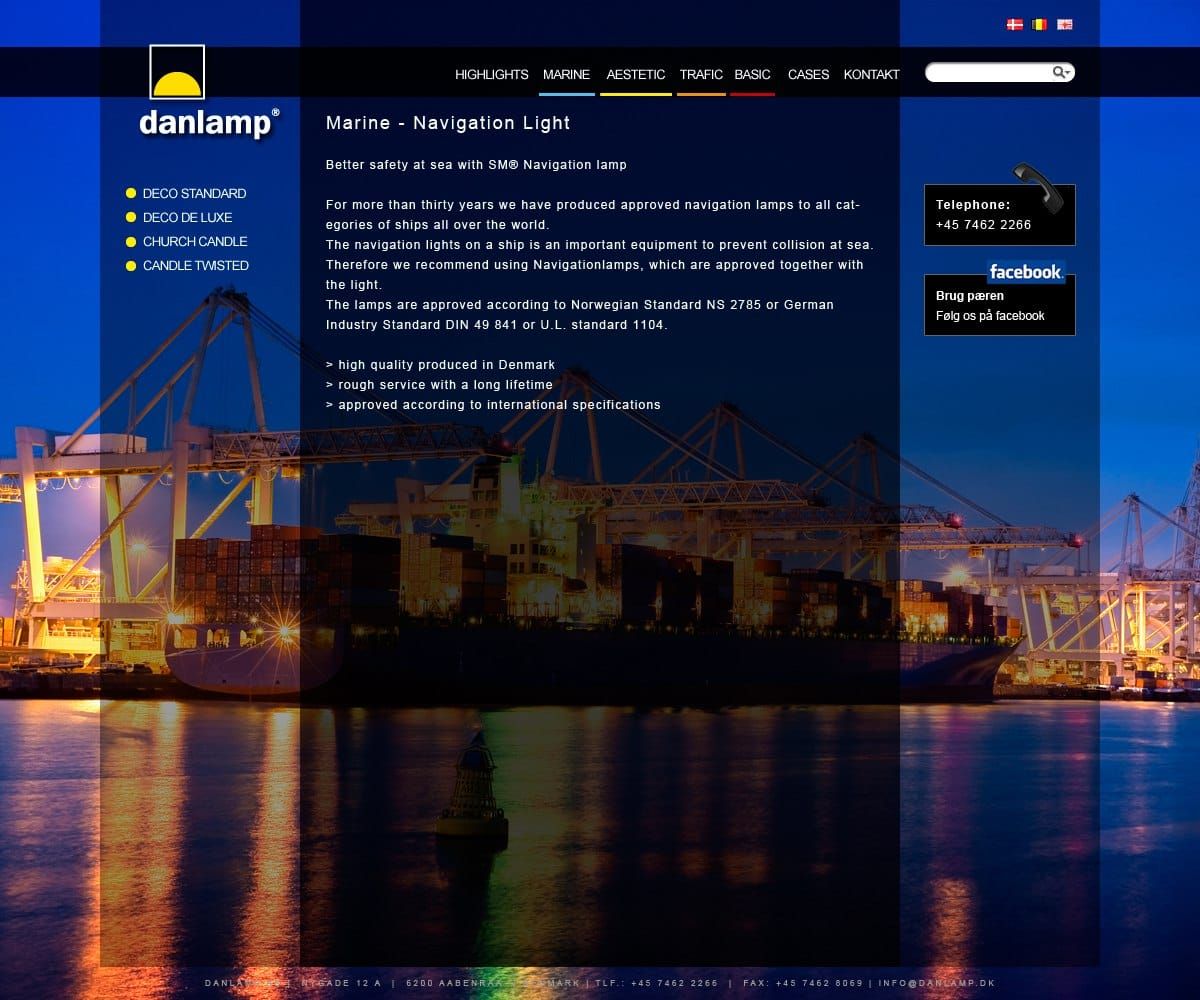 Web design showcasing navigation lamps with maritime imagery of illuminated cargo ship at port
