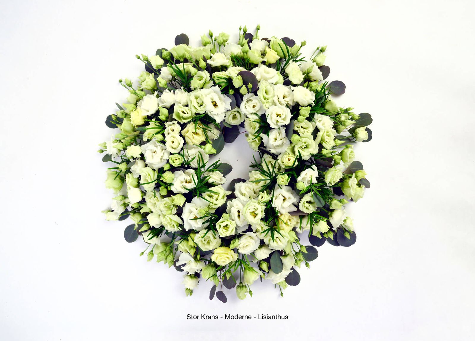 Product photography of white and pale green funeral wreaths with eucalyptus leaves in elegant arrangement