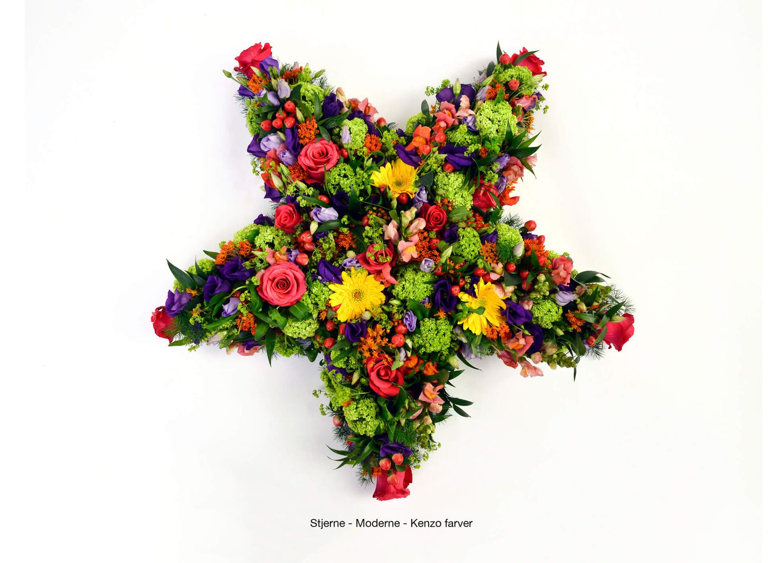 Art direction showcasing vibrant floral wreath arrangement with roses, gerberas and greenery for funeral catalogue