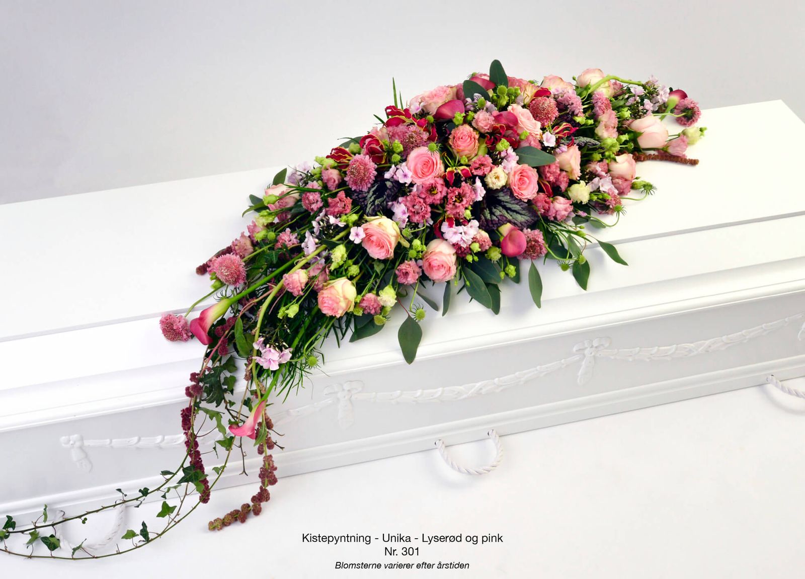 Art direction and graphic layout of pink casket spray featuring roses, carnations and cascading greenery