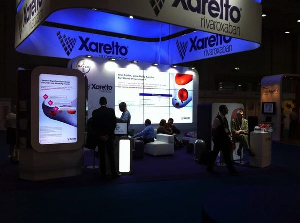 Bayer Xarelto exhibition stand at medical congress with large illuminated screens and digital displays — event design, digital convention platform and congress toolbox for pharmaceutical industry
