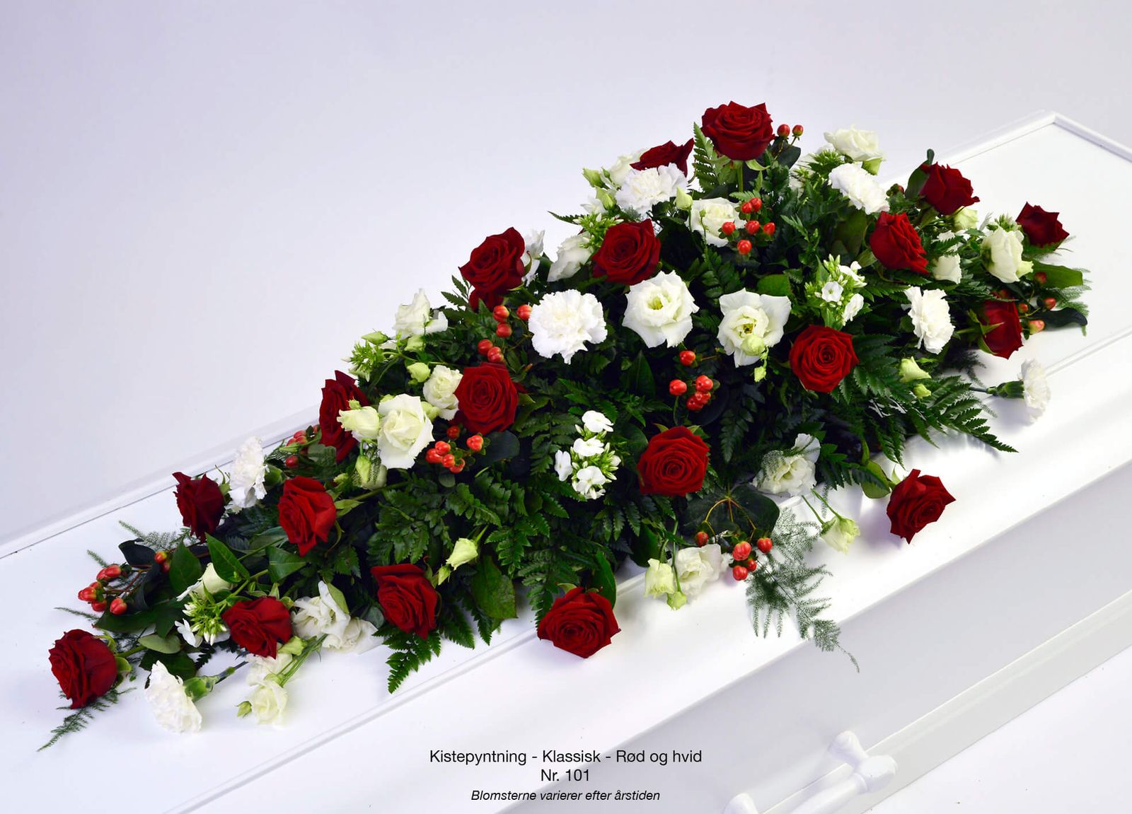 Product photography layout of classic red and white floral casket spray for funeral catalogue