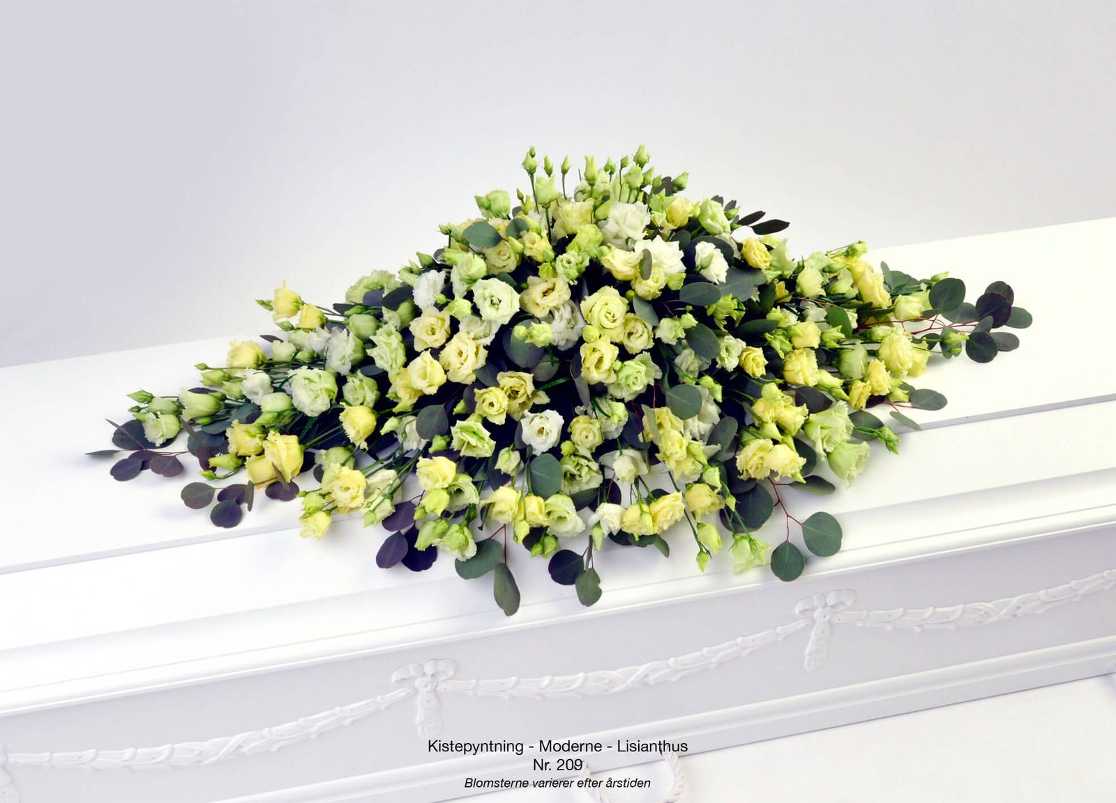 Product photography of yellow and white funeral arrangement with eucalyptus foliage for florist catalog