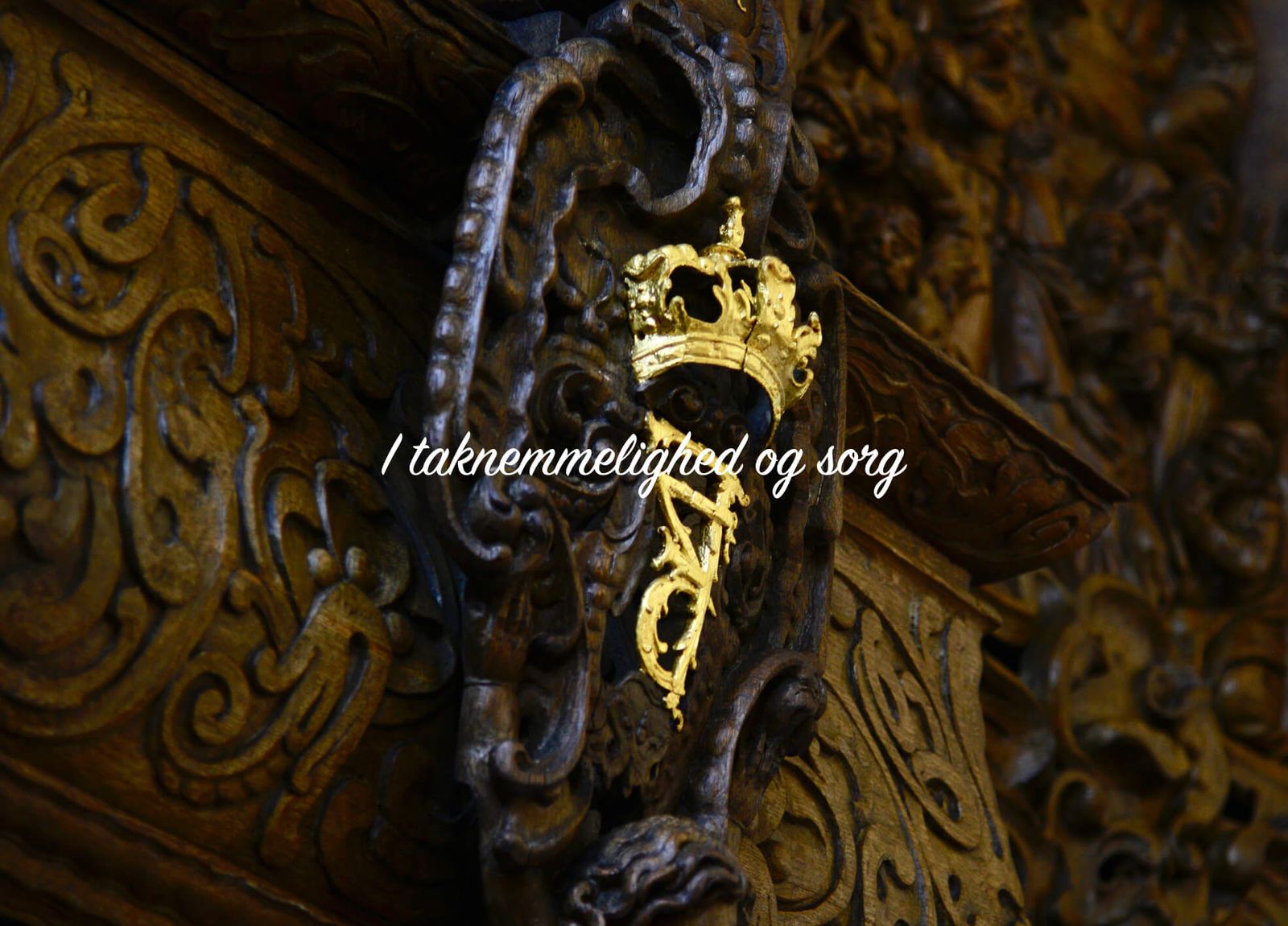 Ornamental baroque floral arrangement featuring gilded crown detail in funeral catalogue design