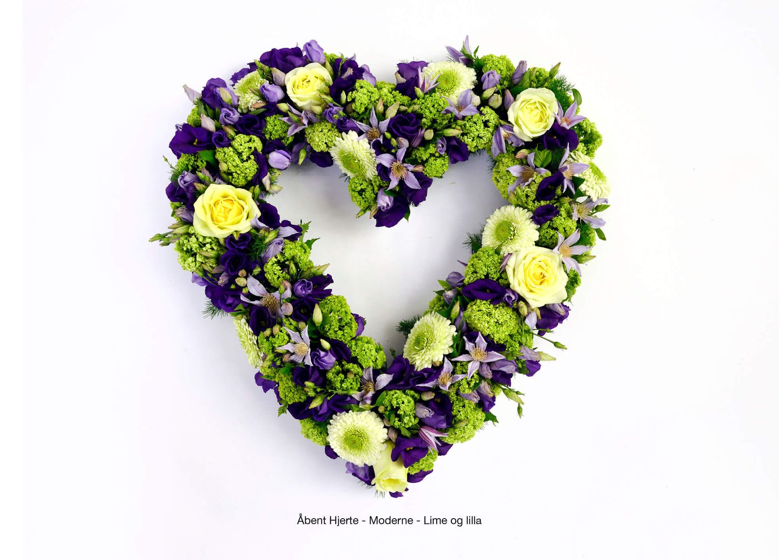 Art direction of purple and green heart wreath with roses and chrysanthemums for funeral catalogue