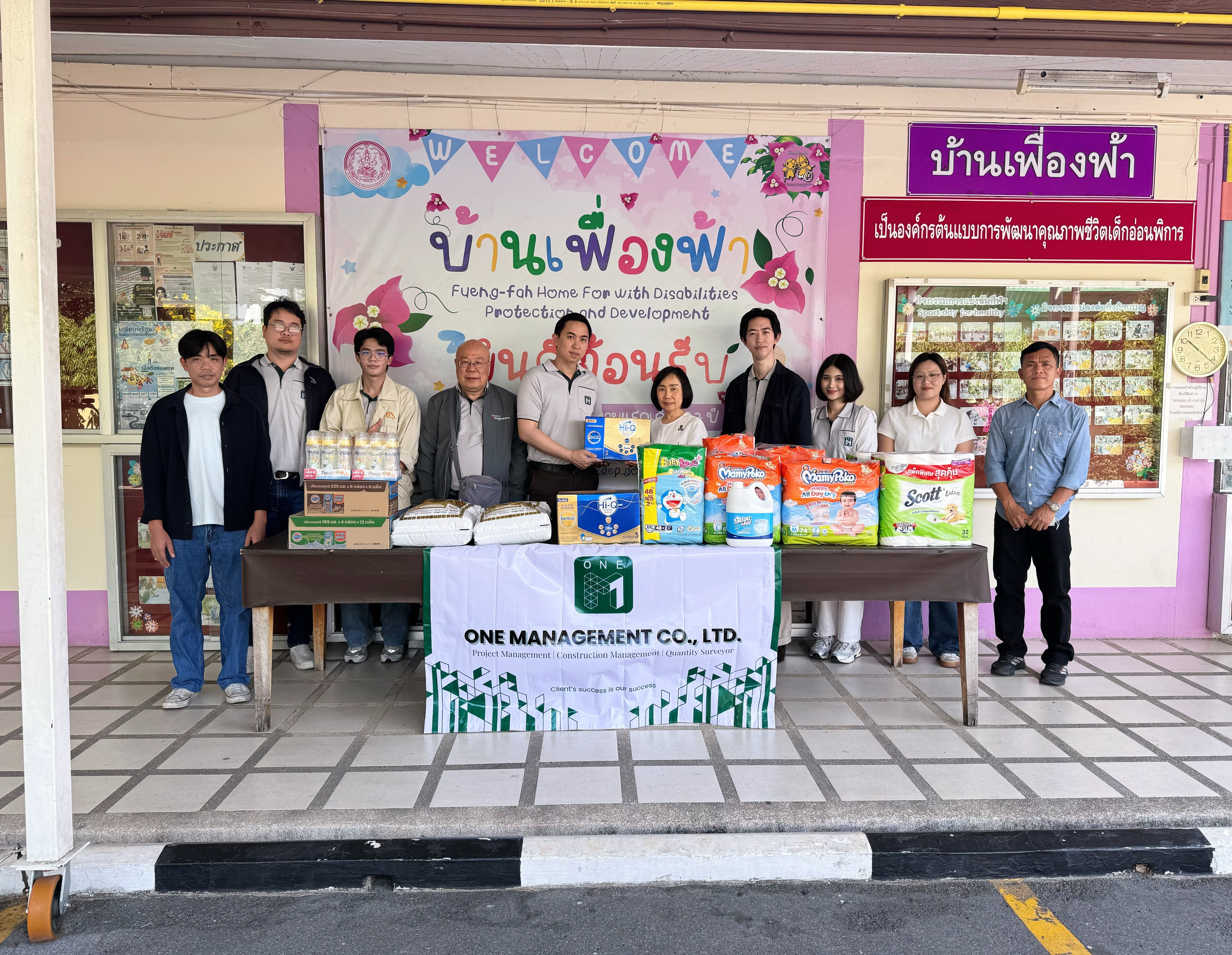 ONE-M team members presenting essential supplies during a CSR activity at Ban Fueng Fah Home for the Disabled in Nonthaburi.