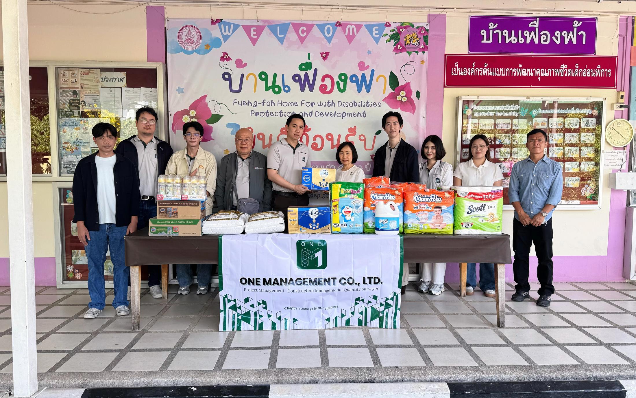 ONE-M team members presenting essential supplies during a CSR activity at Ban Fueng Fah Home for the Disabled in Nonthaburi.