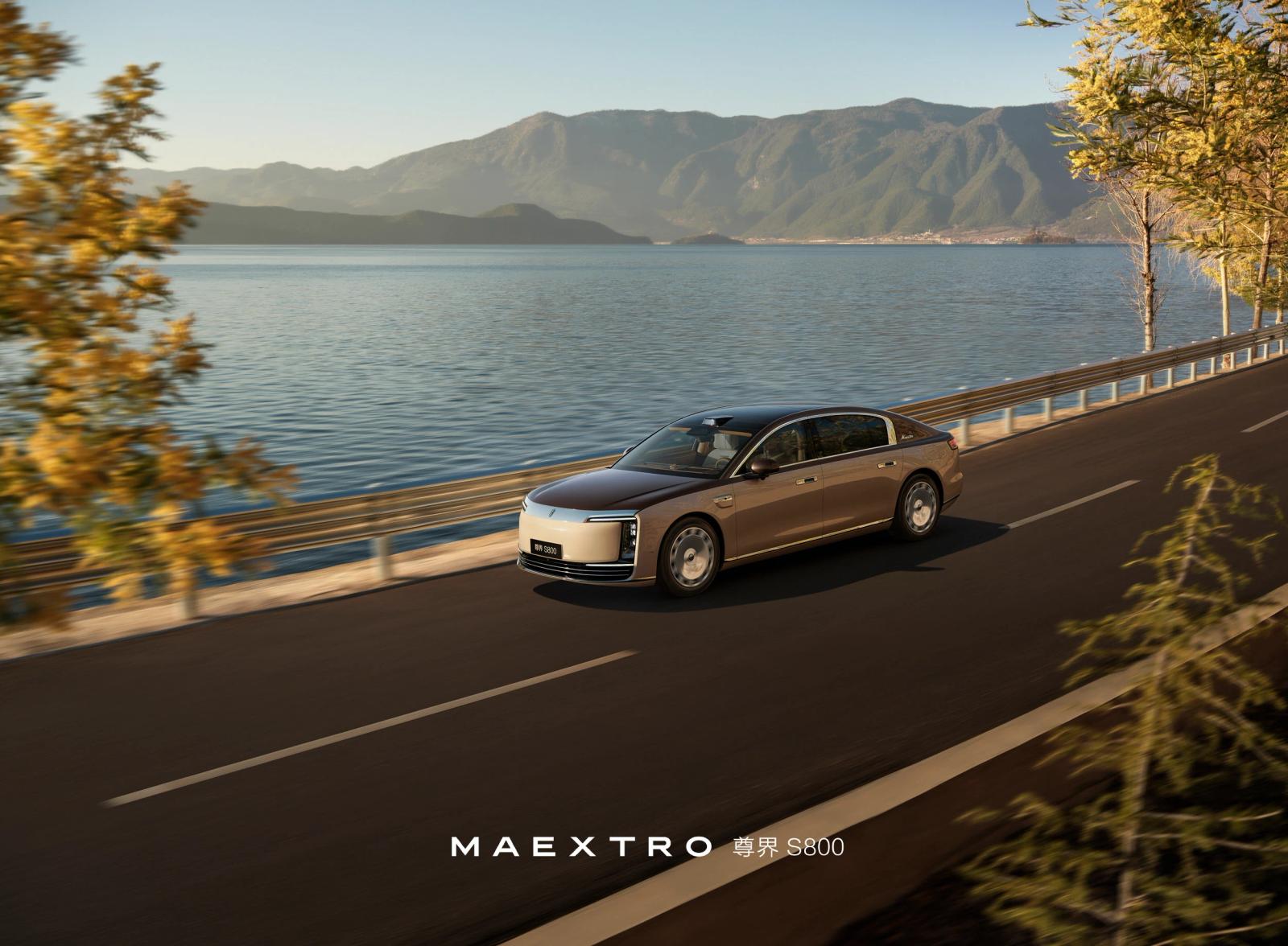 White electric sedan driving on an open road