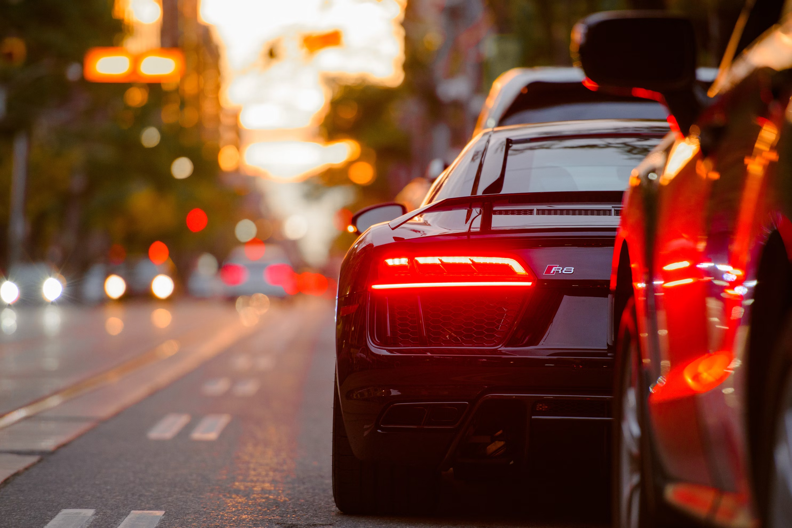 Red tail lights of a sports car on a city street