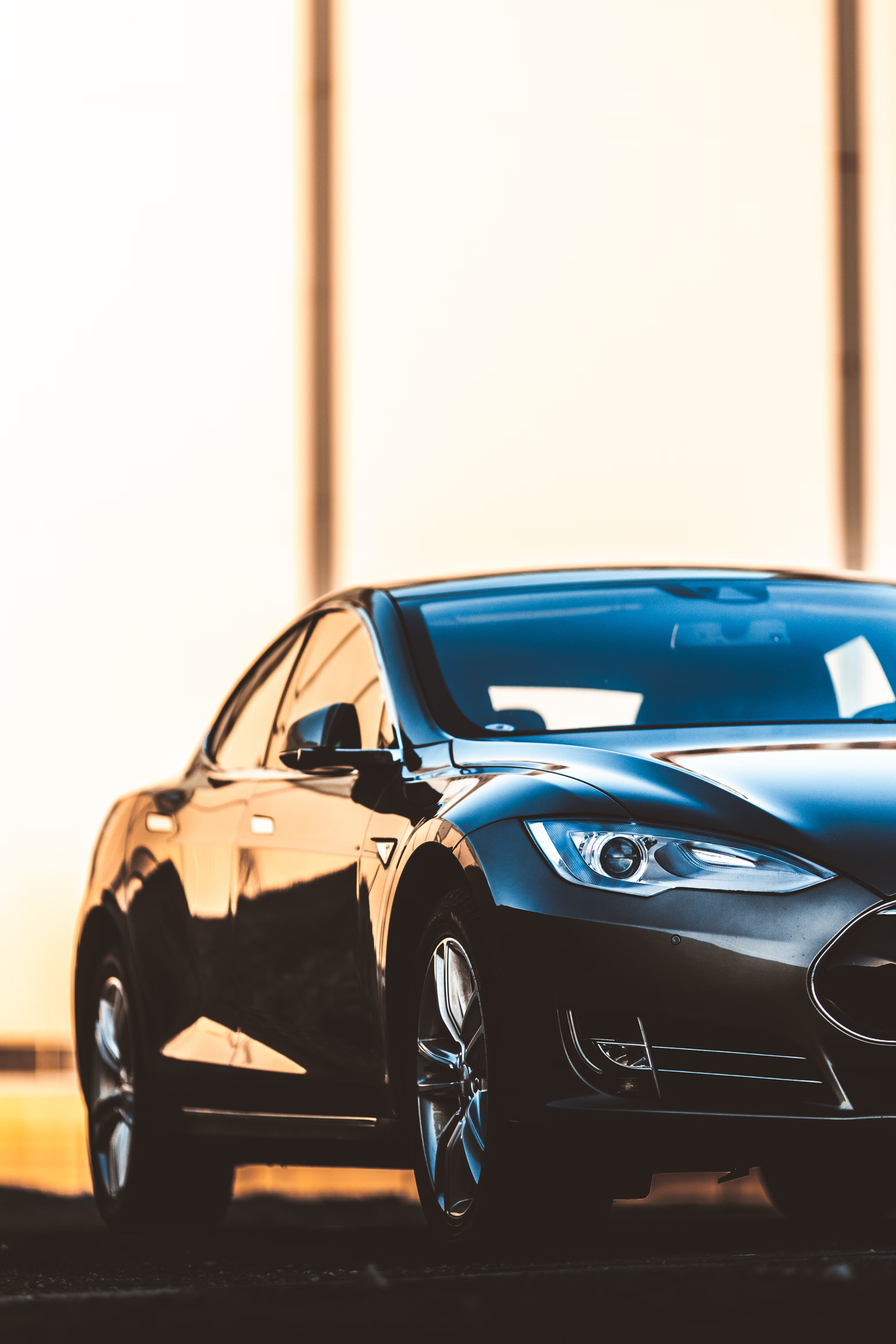 Dark blue electric sedan, close-up of the headlight