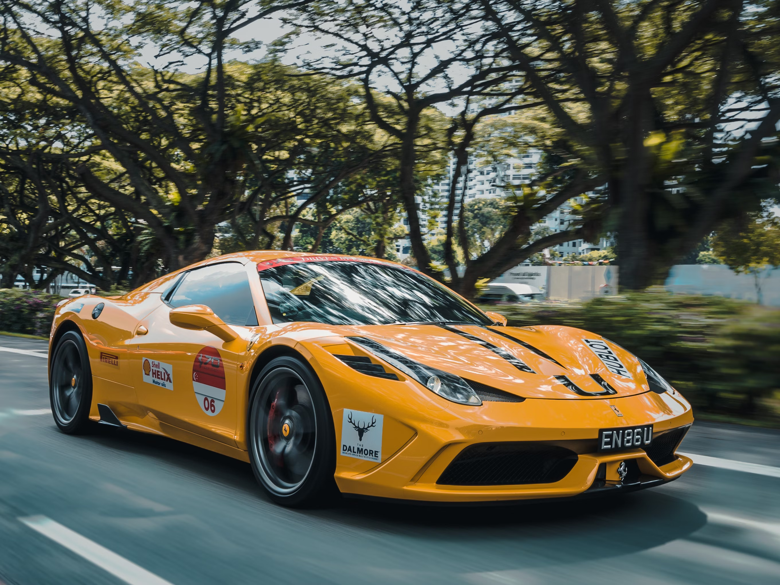 Yellow sports car with racing numbers