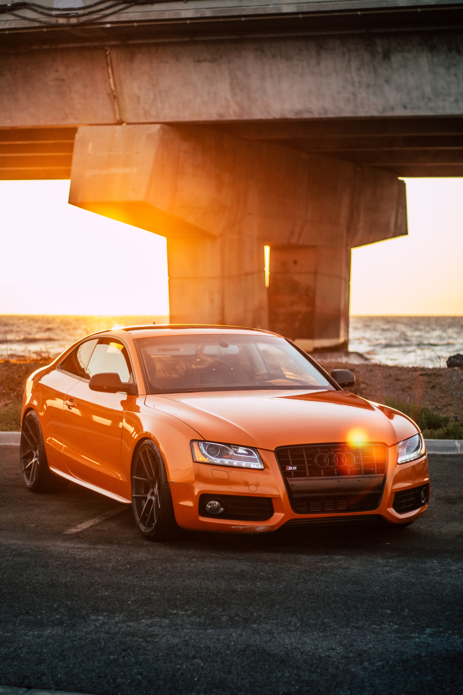 Orange sports car at sunset