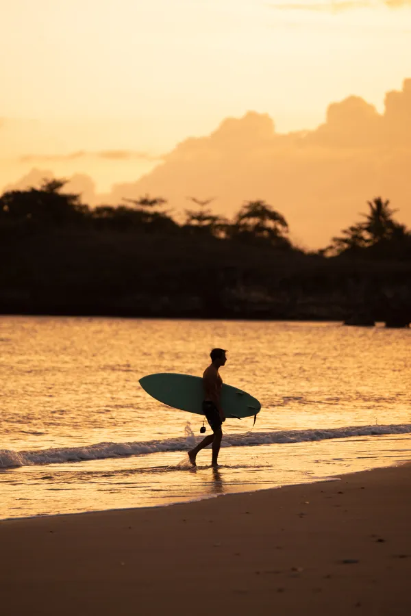 Surfing in front of Alamayah