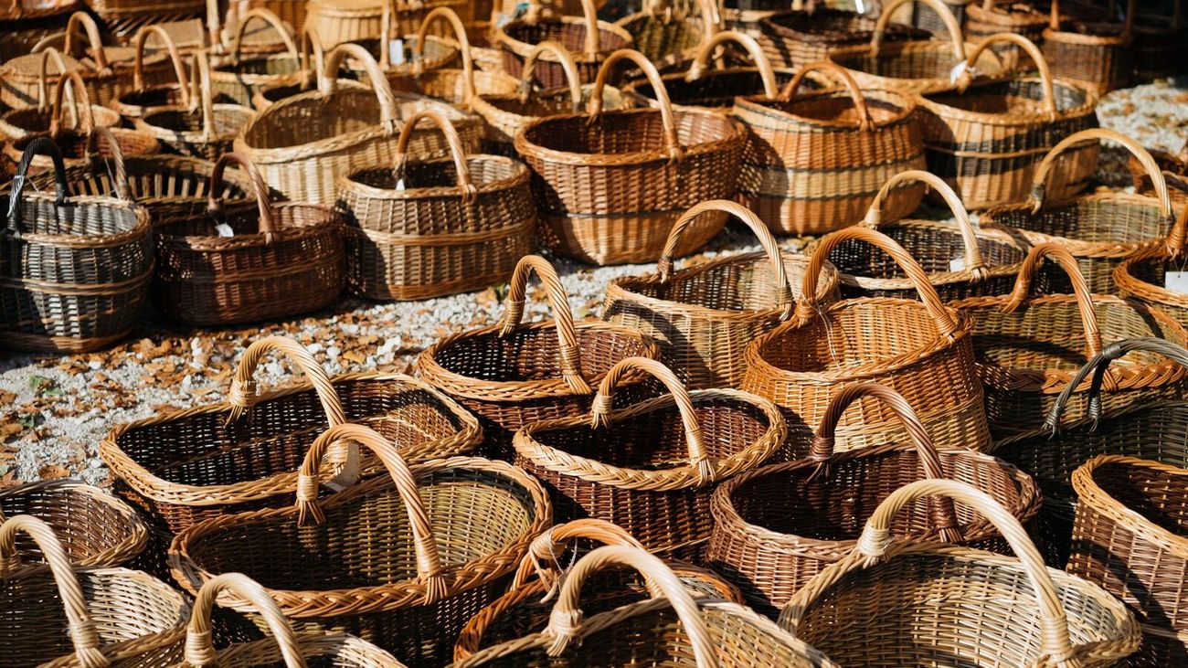 Rows of handmade wicker baskets catching afternoon sun at an outdoor market.