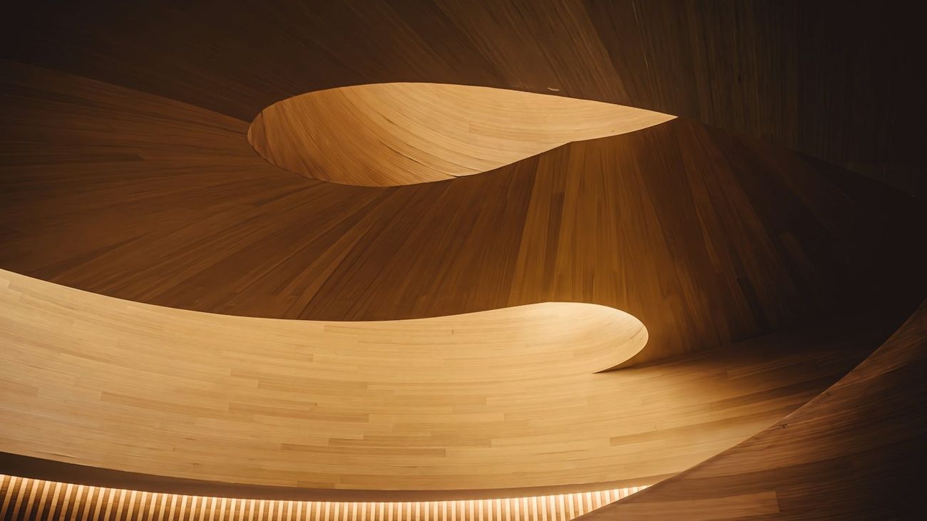 Curved pale timber ceiling lit by warm concealed lighting