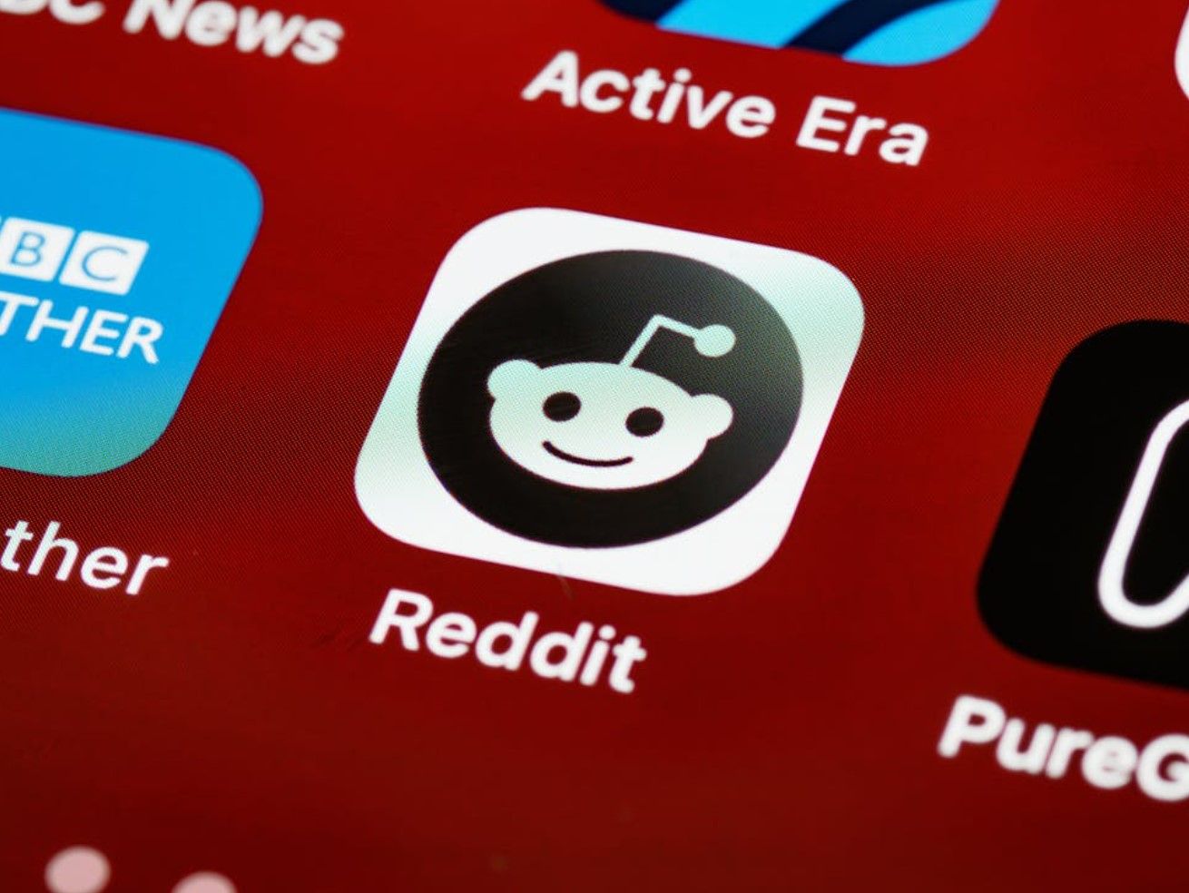 a closeup on the reddit logo on a screen