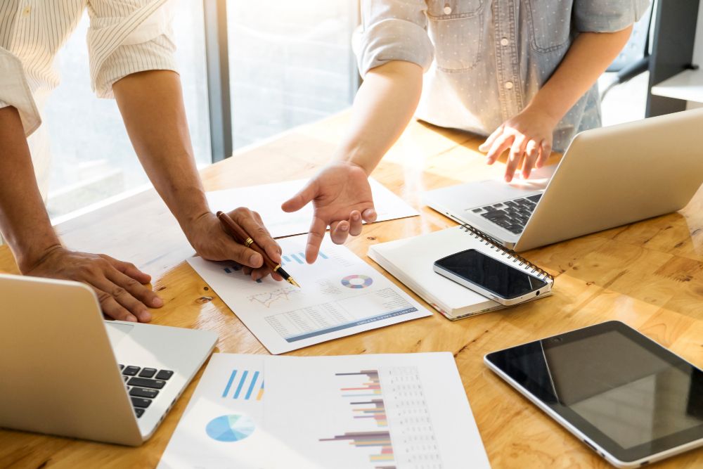 two men looking through graphs and strategiesfor SEO improvement