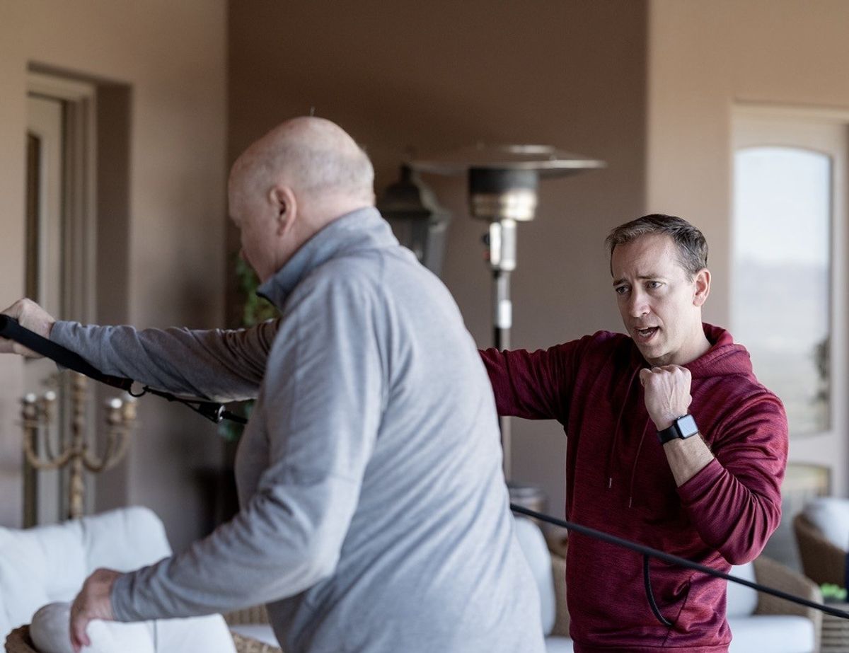 Personal trainer coaching a client through a movement
