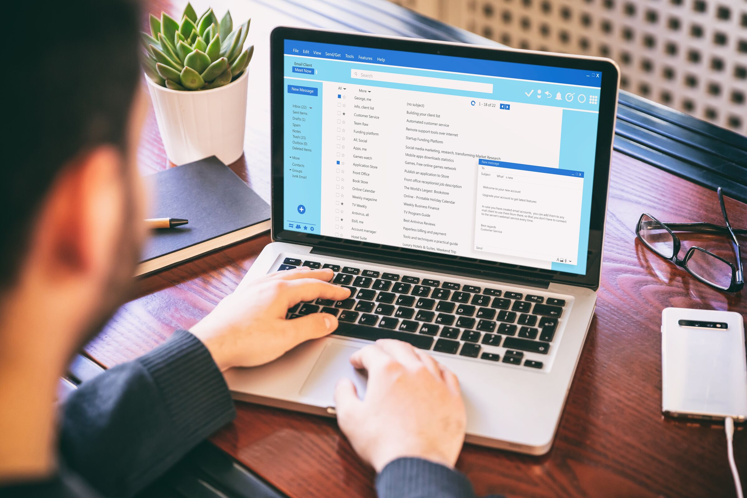 Someone working through their email on a laptop