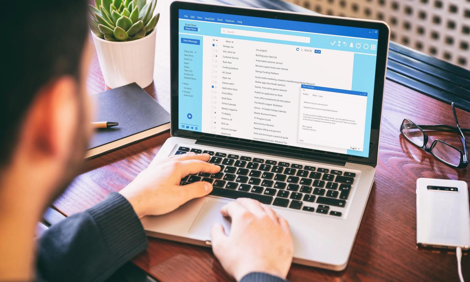 Someone working through their email on a laptop