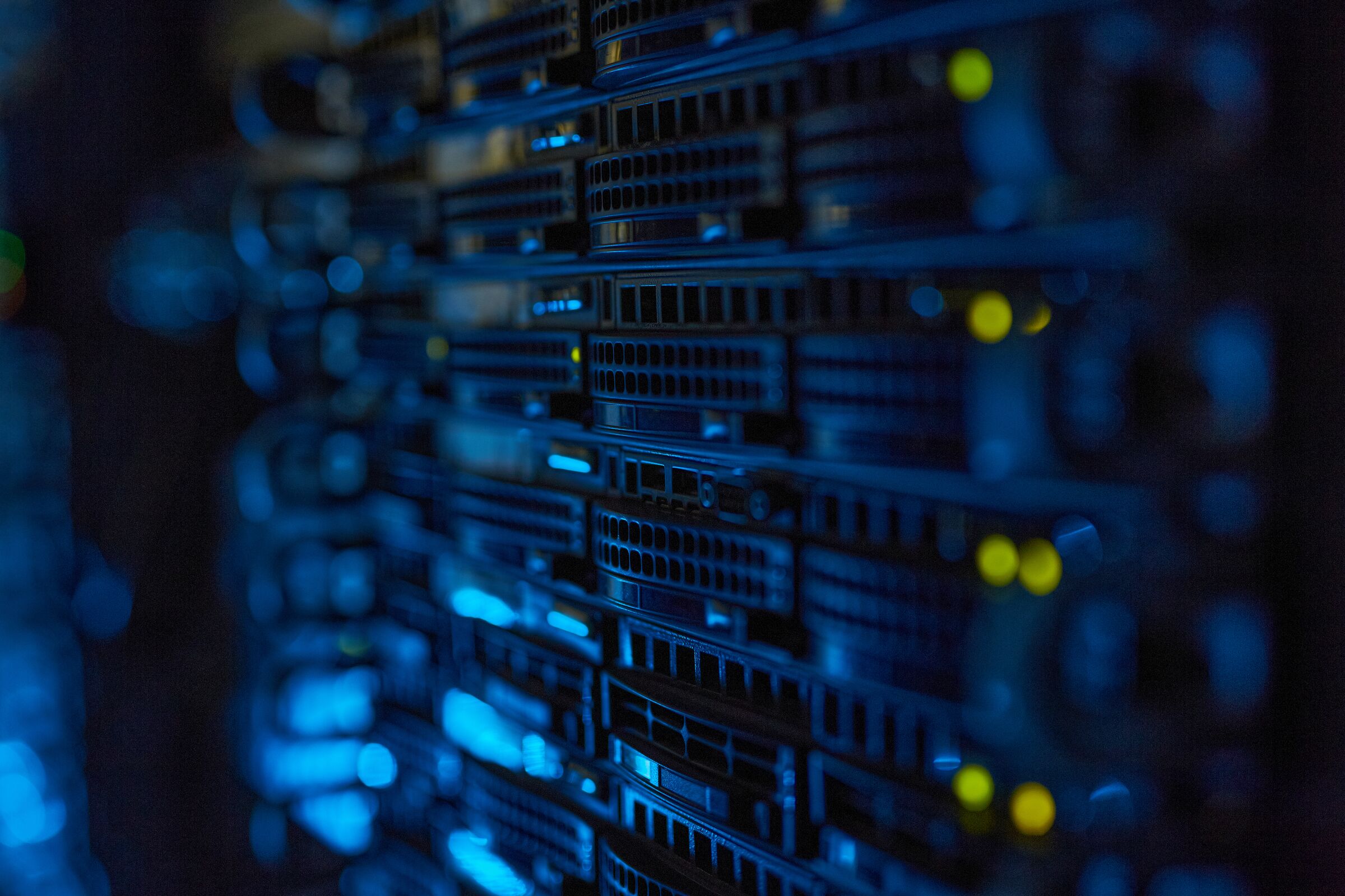 Rows of servers with blue lights in a data centre