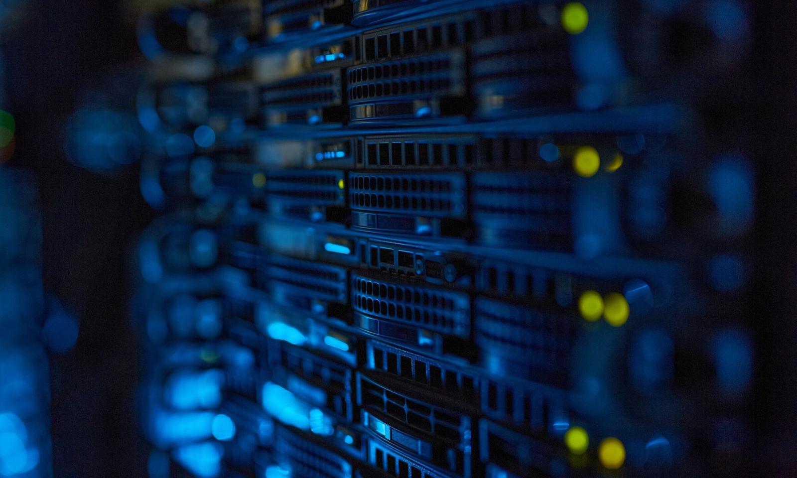 Rows of servers with blue lights in a data centre