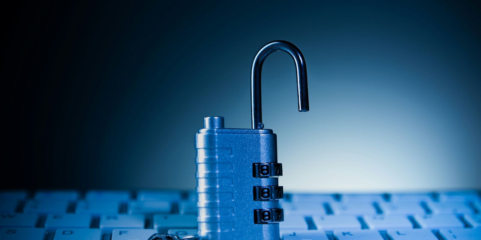 An unlocked padlock on a computer keyboard