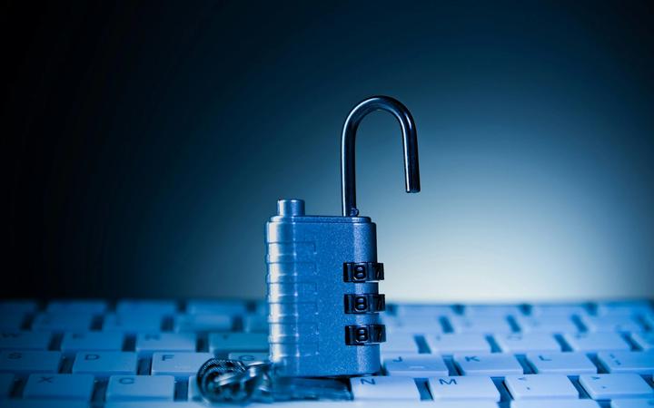 An unlocked padlock on a computer keyboard