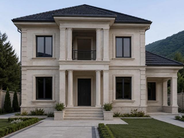 A two-storey private house in the city of Oghuz — a light-coloured stone-clad facade, a columned entrance portal and a mountain view in the background