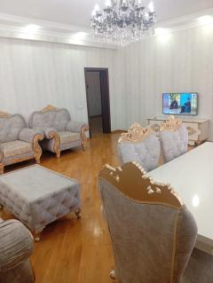 The living room of a handed-over house — sofa set and television wall