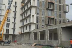 Construction in a residential development — a mobile crane, floors at the masonry stage and a clad section