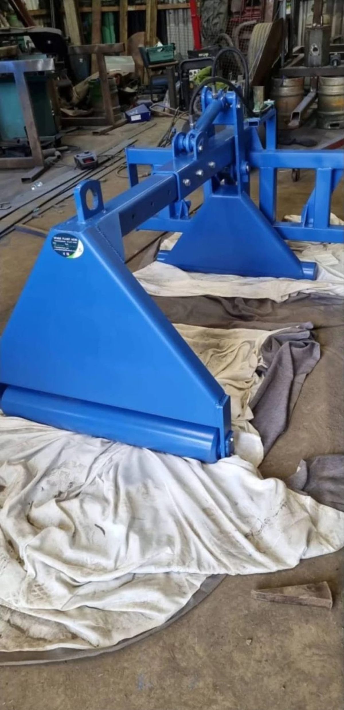 Blue three-point linkage frame with hydraulic ram