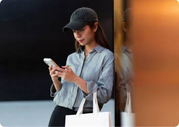 Woman with shopping bag looking at her phone