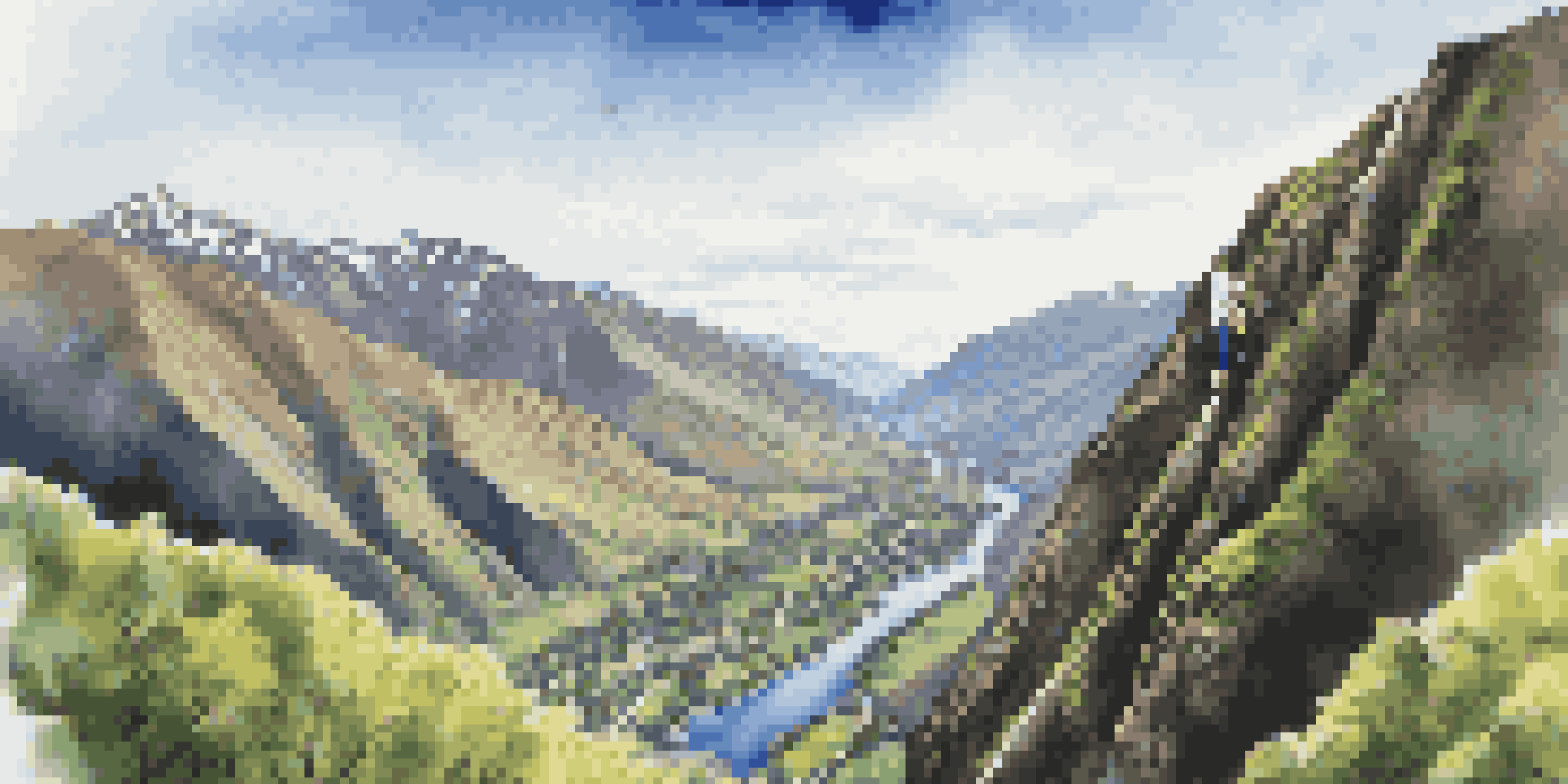 A jumper free-falling from the Nevis Bungy platform, surrounded by green valleys and mountains, with the Nevis River visible below.