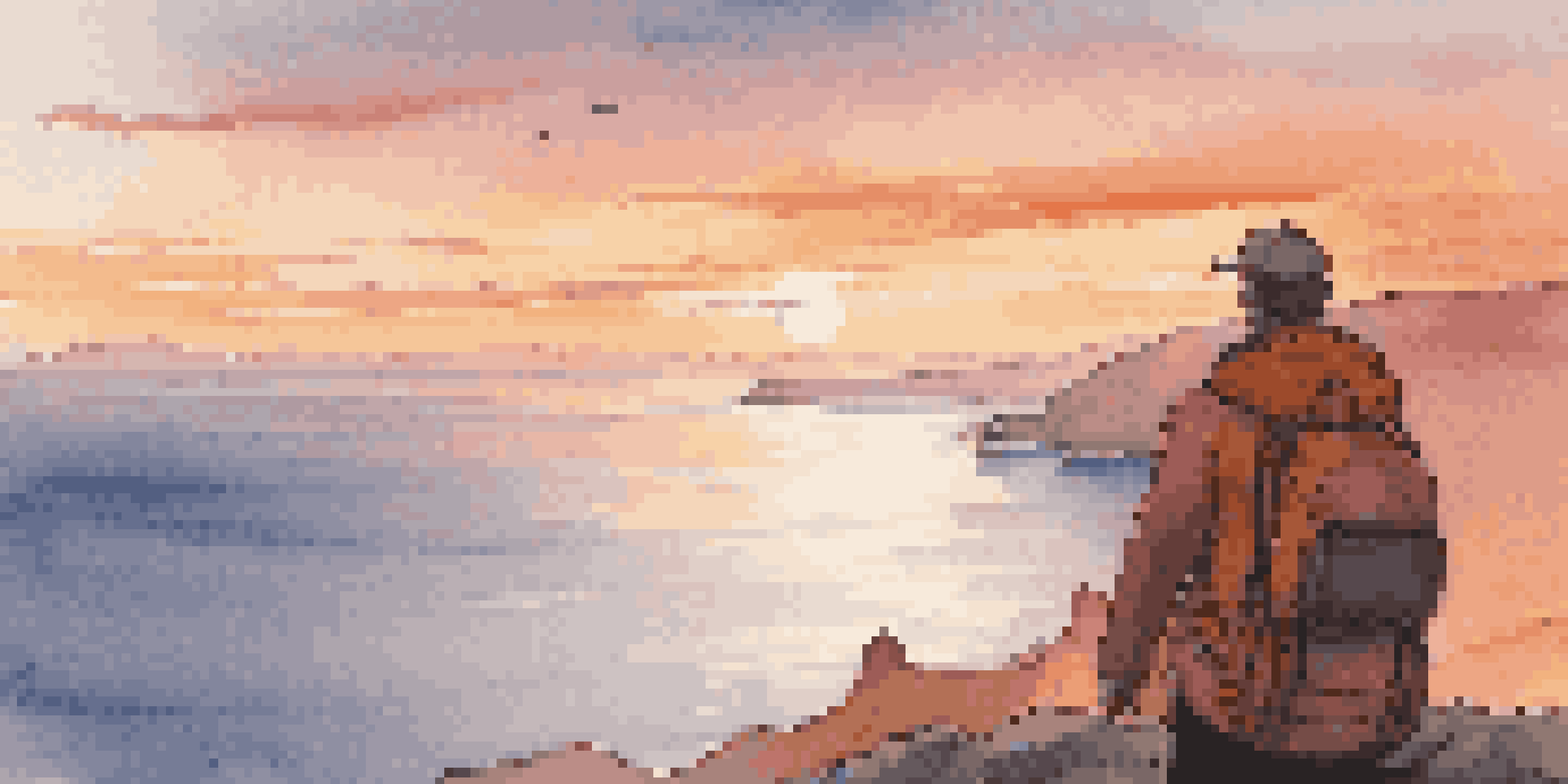 A traveler with a light backpack standing on a cliff at sunset, overlooking the ocean.