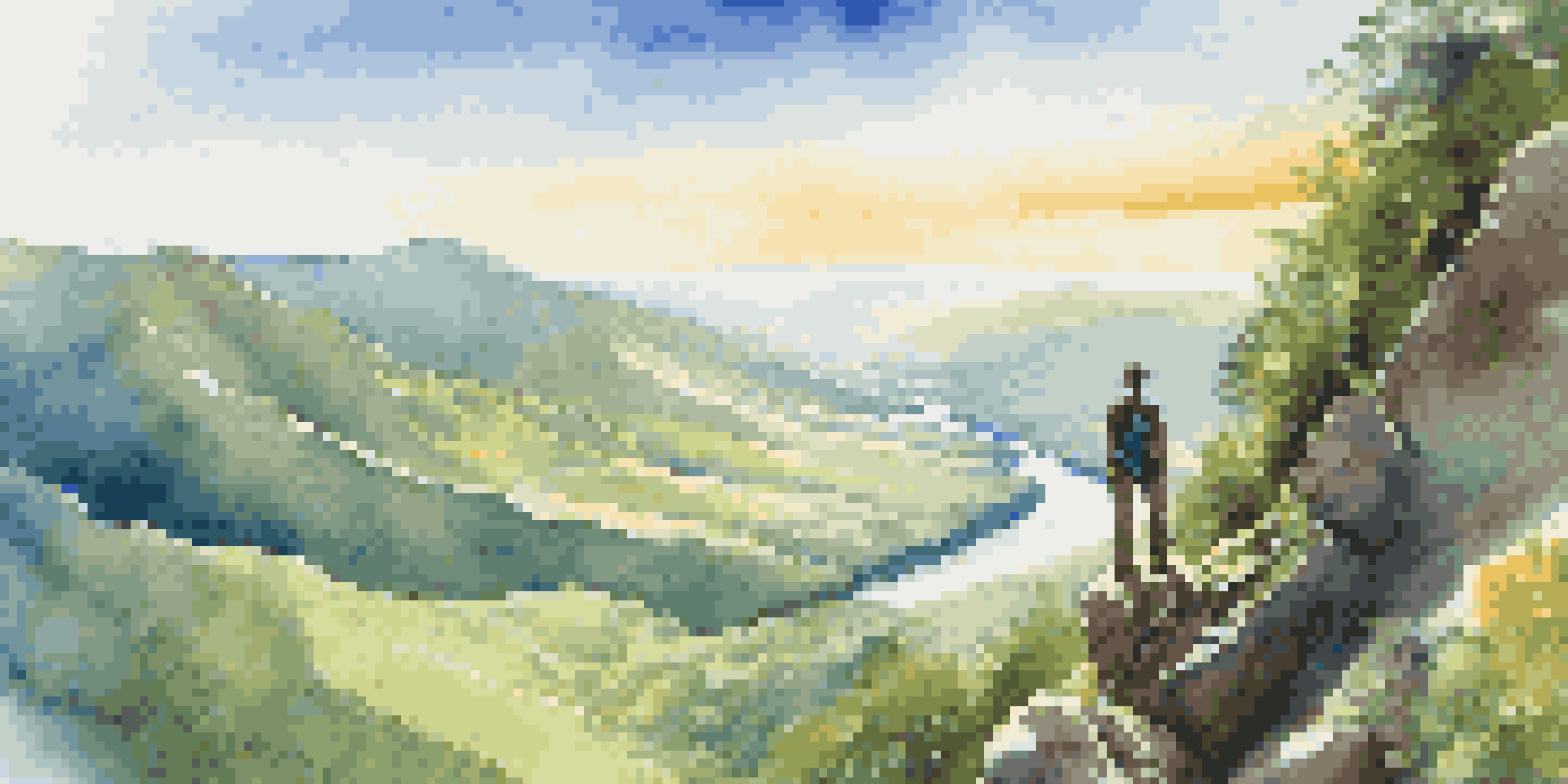 A hiker on a mountain peak with a stunning view of a green valley and a river under a blue sky.