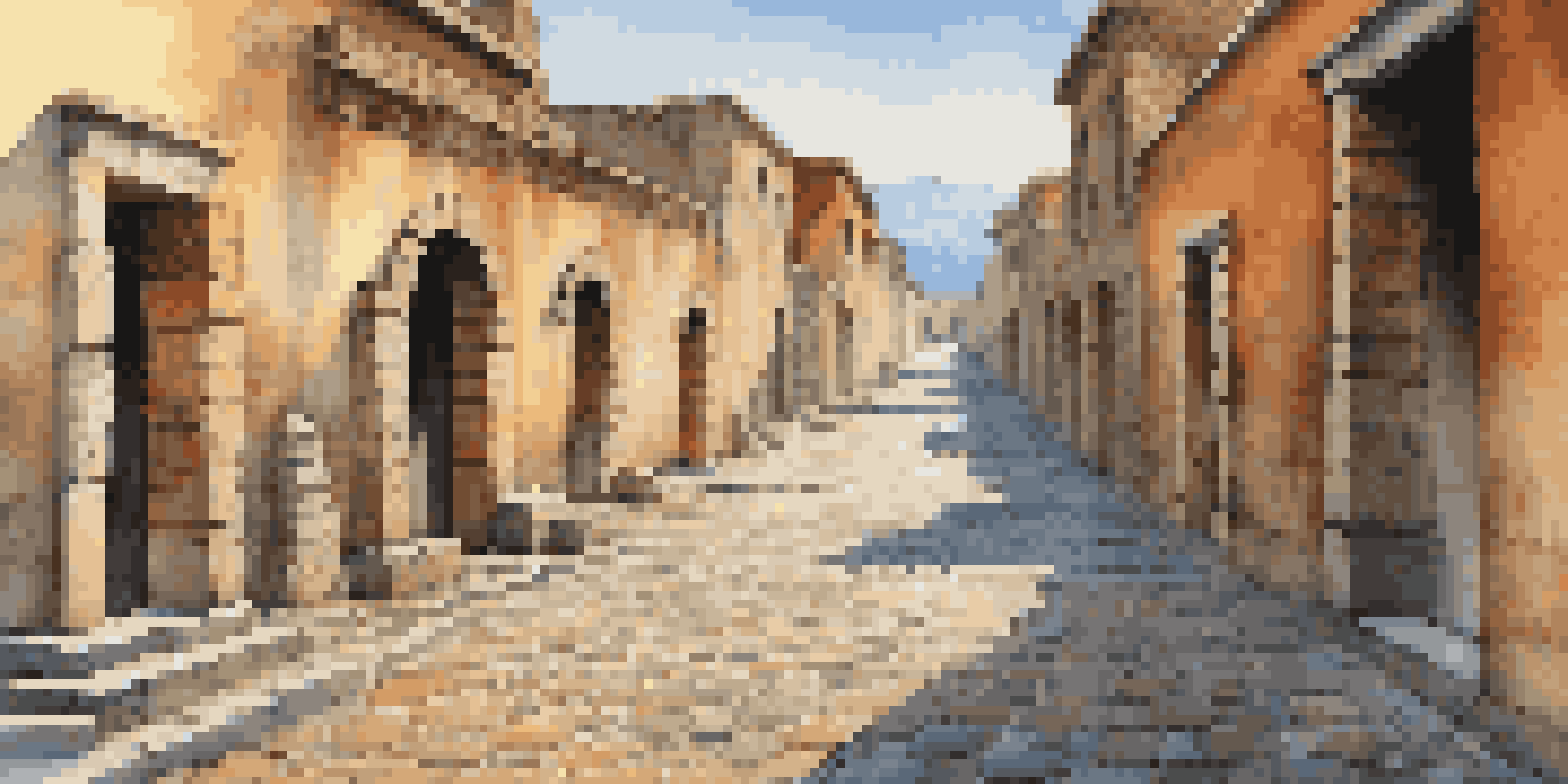 A detailed view of the cobblestone streets in Pompeii, with raised stones, ancient buildings, and vibrant frescoes under a clear blue sky.