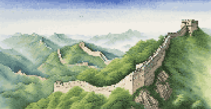 A wide-angle view of the Great Wall of China on green mountains with a clear sky.