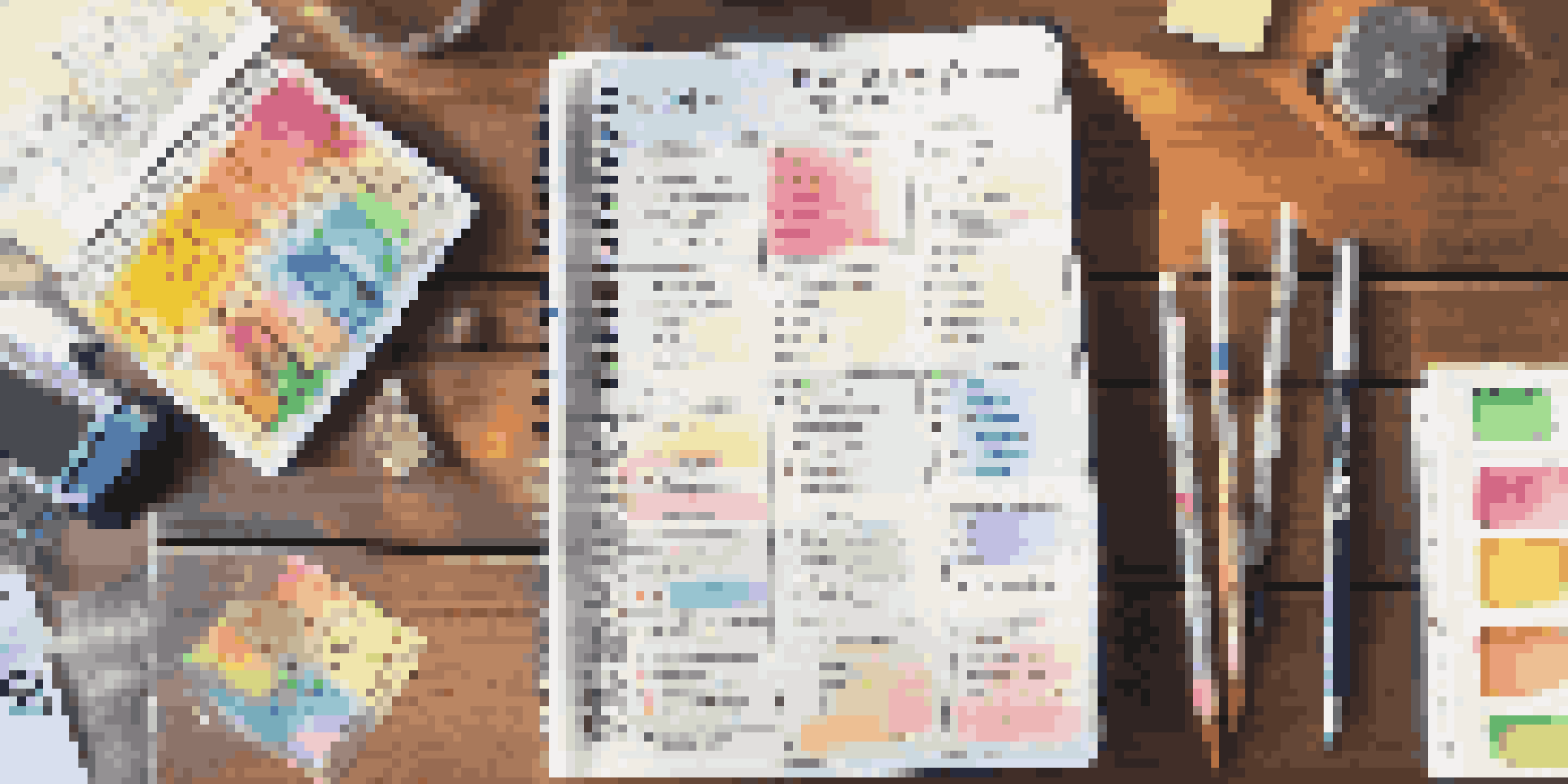 A travel budget planner on a wooden table with a calculator and colorful pens, illuminated by sunlight.