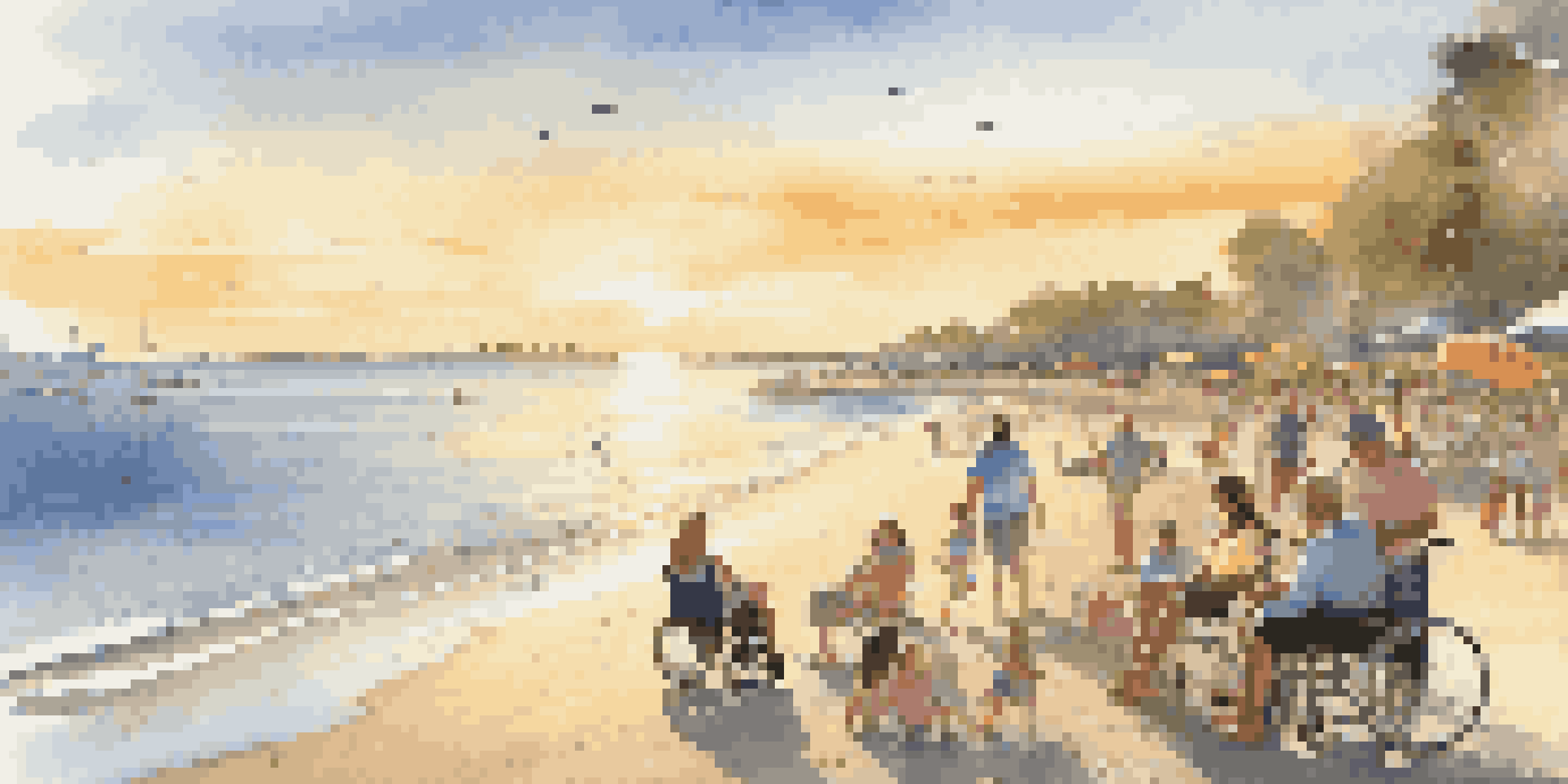 A tranquil beach with a wheelchair-accessible ramp, vibrant umbrellas, and families enjoying the sunset by the water.