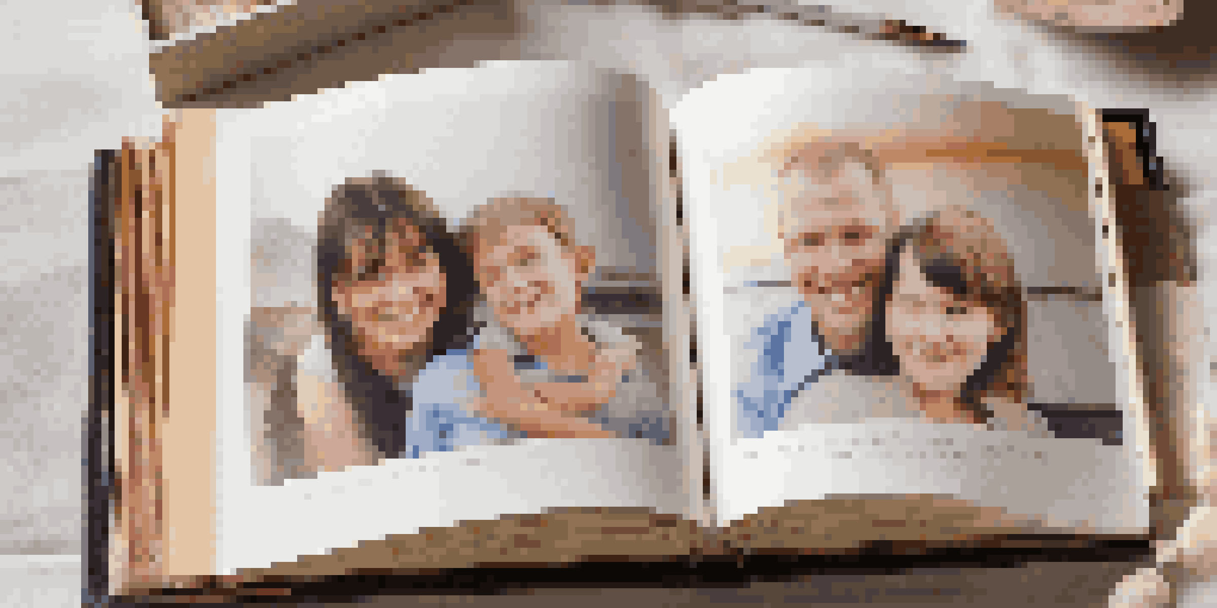 A family photo album with colorful pages and handwritten notes, displayed on a table in warm lighting.