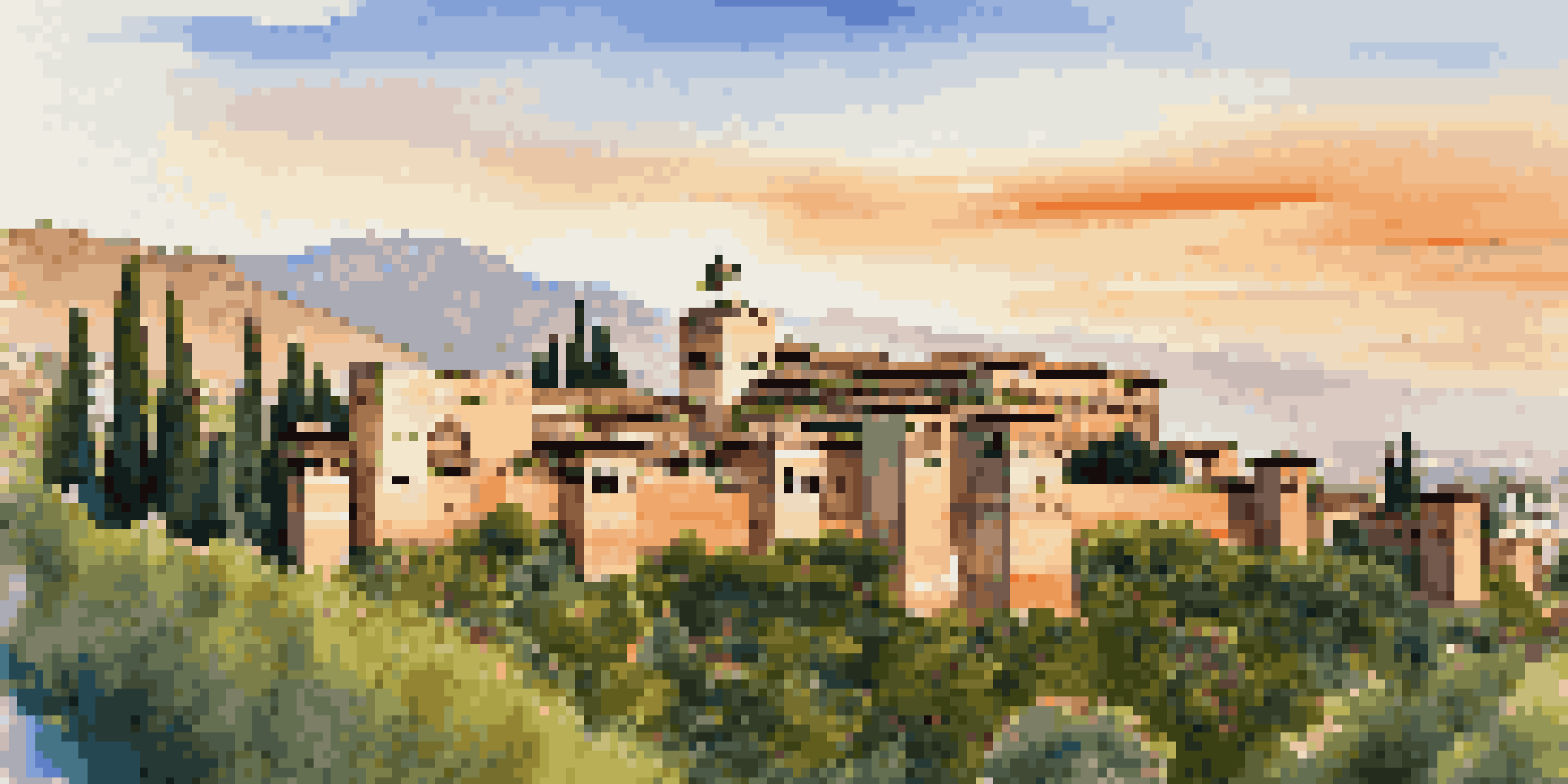 A panoramic view of the Alhambra palace illuminated by the sunset, highlighting its intricate architecture and gardens.