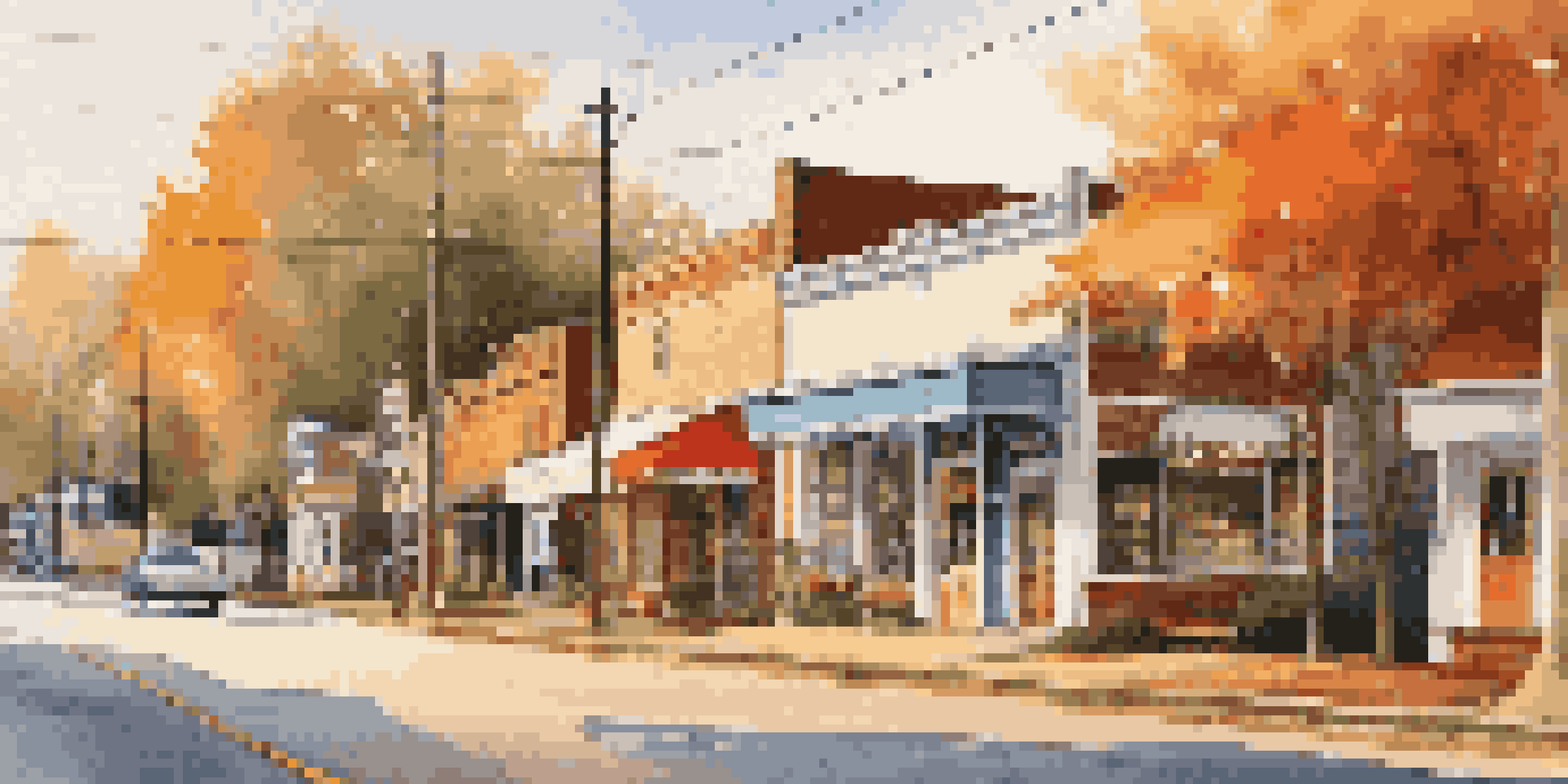 A small-town street in Hawkins, Georgia, with vintage 1980s storefronts and autumn leaves under a sunset sky.