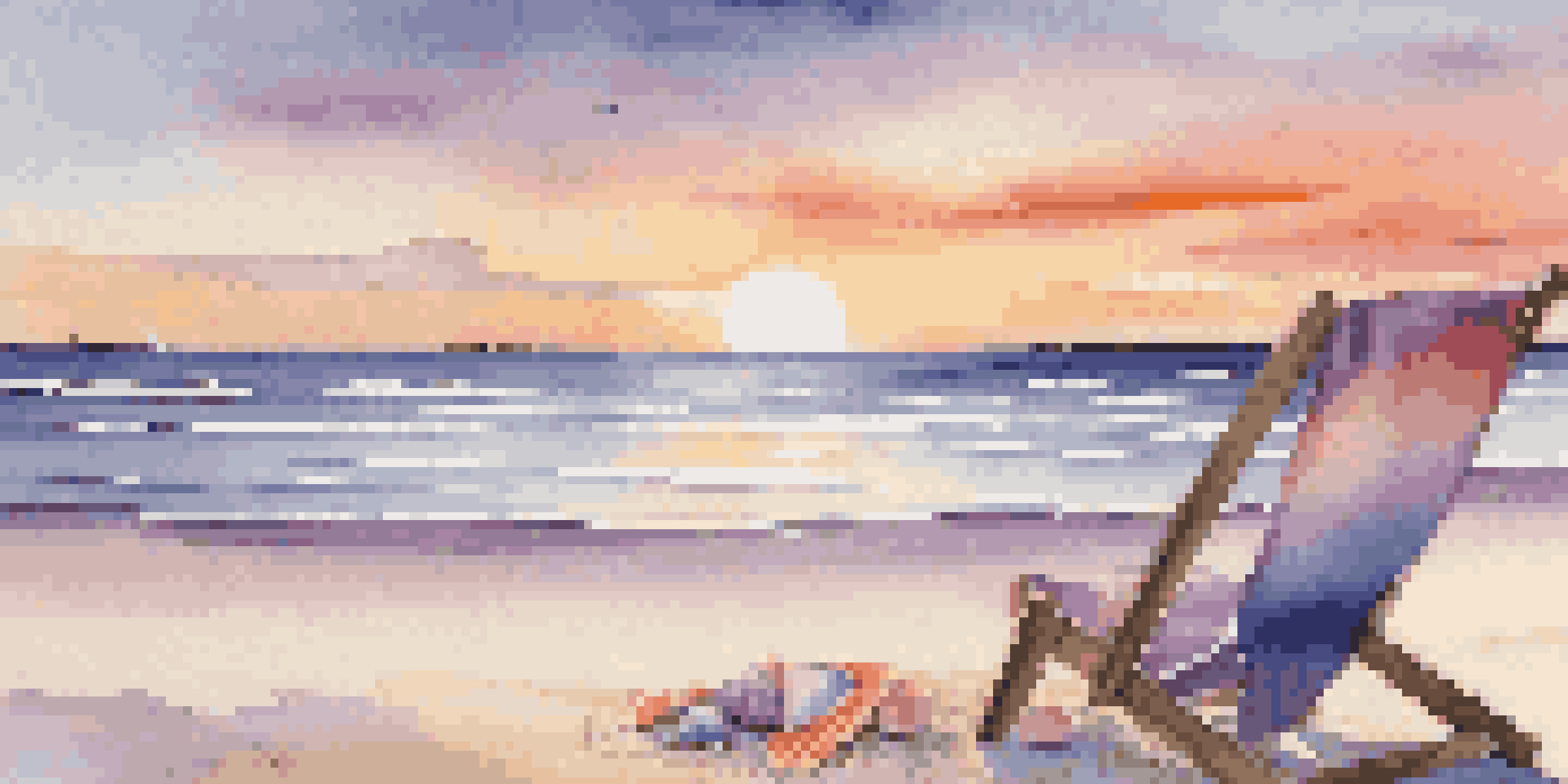 A tranquil beach scene during sunset, with colorful skies and a beach chair.
